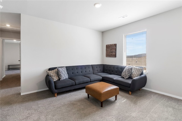 carpeted living room featuring baseboards, visible vents, and recessed lighting