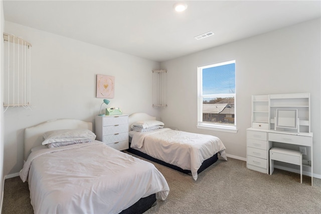 bedroom with baseboards, visible vents, and carpet