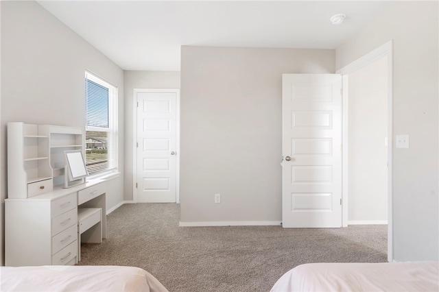 carpeted bedroom featuring baseboards
