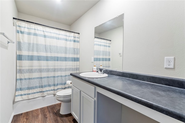 full bath featuring toilet, vanity, wood finished floors, and shower / bathtub combination with curtain