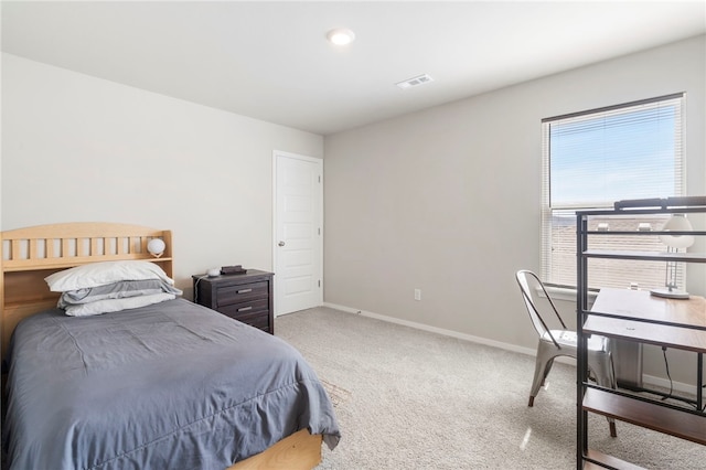 carpeted bedroom featuring visible vents and baseboards