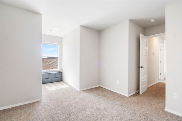 interior space featuring baseboards and carpet flooring