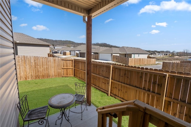 view of yard with a fenced backyard, a residential view, and a patio
