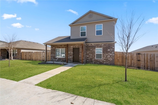 traditional-style house with brick siding, fence private yard, a front yard, and a gate