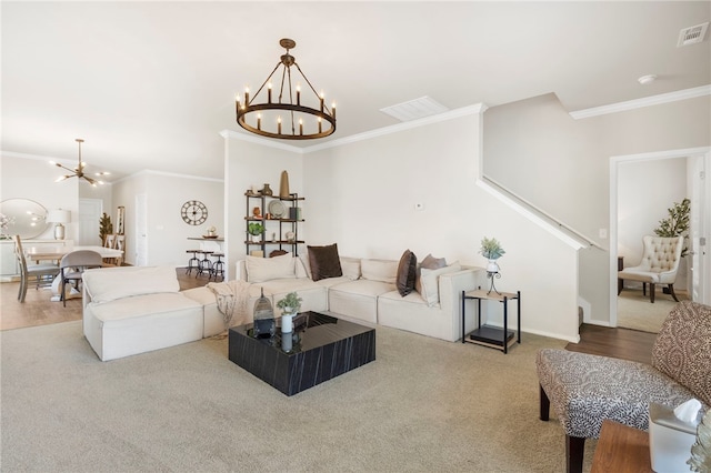 living room featuring stairway, visible vents, ornamental molding, and an inviting chandelier