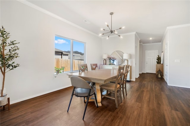 dining room featuring dark wood finished floors, baseboards, a notable chandelier, and crown molding