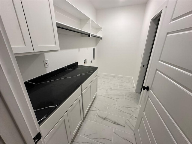 11 Romine Ln, Bella Vista, AR 72715 - laundry area featuring light marble finish flooring and cabinet space