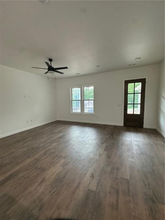 11 Romine Ln, Bella Vista, AR 72715 - unfurnished living room featuring healthy amount of natural light, dark wood finished floors, and a ceiling fan