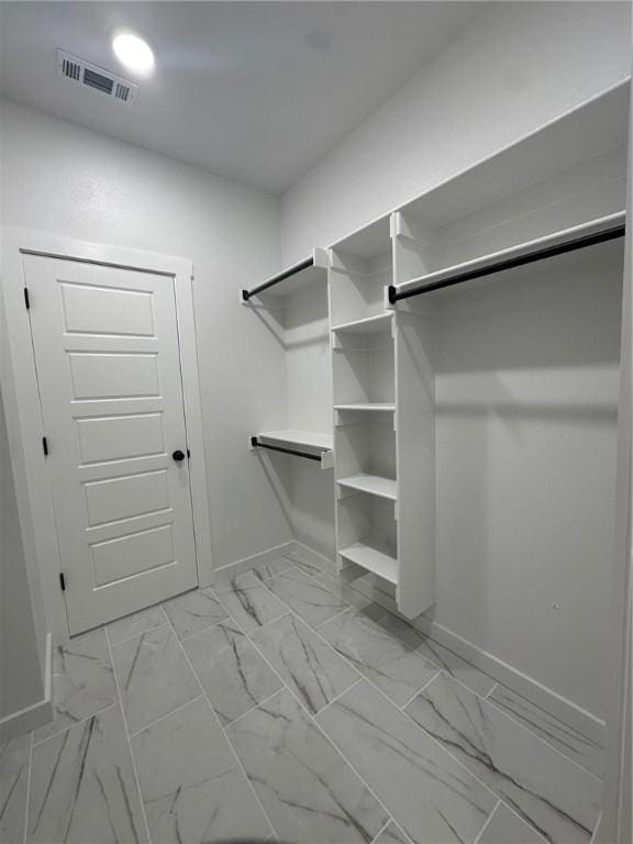 11 Romine Ln, Bella Vista, AR 72715 - walk in closet with light marble finish floors