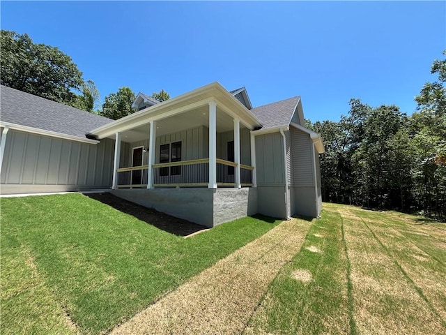 11 Romine Ln, Bella Vista, AR 72715 - view of property exterior with board and batten siding, a lawn, and roof with shingles