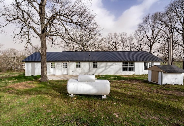 291 E Pilcher Rd, Kansas, OK 74347 - rear view of house with metal roof, a yard, and a patio