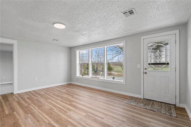 291 E Pilcher Rd, Kansas, OK 74347 - foyer entrance featuring light wood-type flooring, a textured ceiling, and baseboards