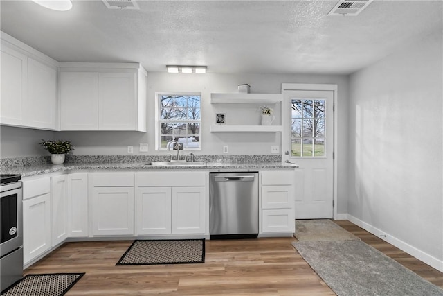 291 E Pilcher Rd, Kansas, OK 74347 - kitchen featuring appliances with stainless steel finishes, a sink, white cabinets, light stone countertops, and a textured ceiling