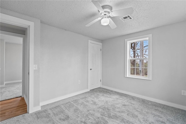 291 E Pilcher Rd, Kansas, OK 74347 - carpeted spare room featuring a textured ceiling, ceiling fan, and baseboards