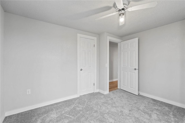 291 E Pilcher Rd, Kansas, OK 74347 - unfurnished bedroom with carpet floors, a textured ceiling, baseboards, and ceiling fan