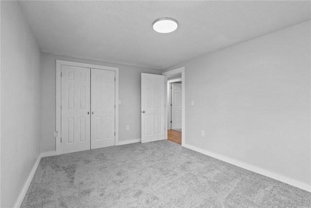 291 E Pilcher Rd, Kansas, OK 74347 - unfurnished bedroom with carpet flooring, a closet, and baseboards