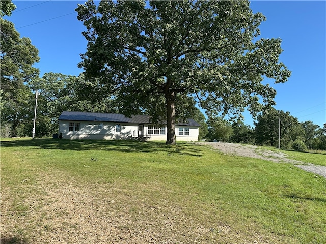 291 E Pilcher Rd, Kansas, OK 74347 - view of front of house featuring a front lawn, driveway, and metal roof