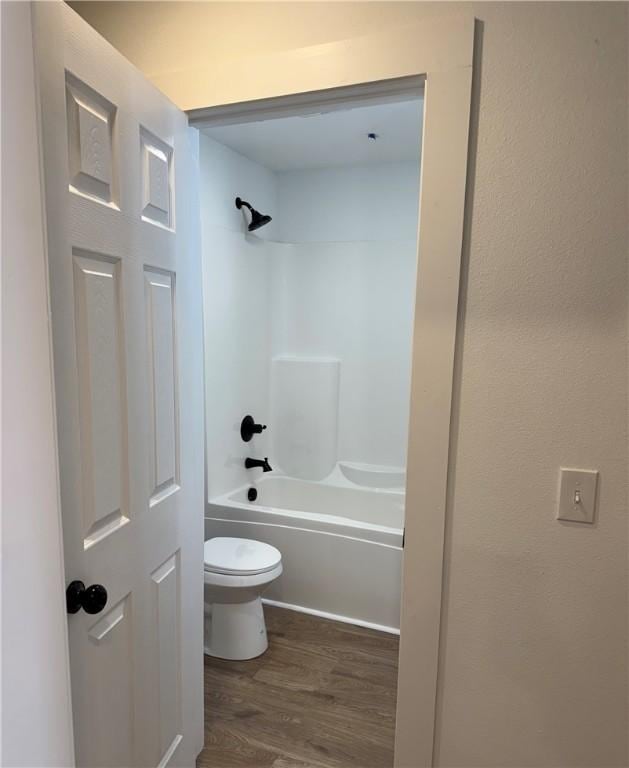 311 Douglas St, Berryville, AR 72616 - full bath featuring toilet, wood finished floors, and bathing tub / shower combination