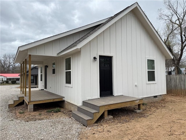 313 Douglas St, Berryville, AR 72616 - back of property featuring crawl space, board and batten siding, and fence