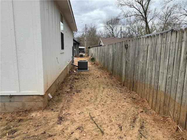 313 Douglas St, Berryville, AR 72616 - view of side of home featuring central AC unit and fence