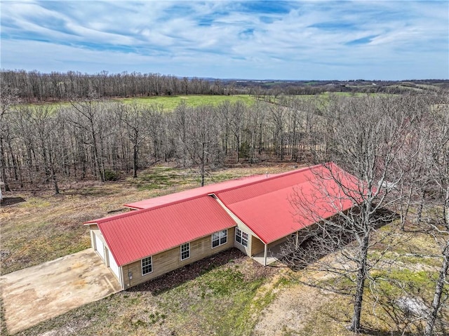 birds eye view of property with a forest view