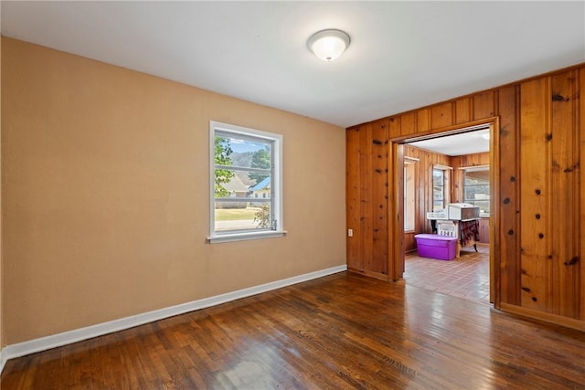 300 Range St, Marshall, AR 72650 - empty room featuring a wealth of natural light, wood finished floors, wood walls, and baseboards