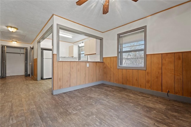 300 Range St, Marshall, AR 72650 - kitchen featuring wainscoting, a textured ceiling, freestanding refrigerator, a ceiling fan, and wood finished floors