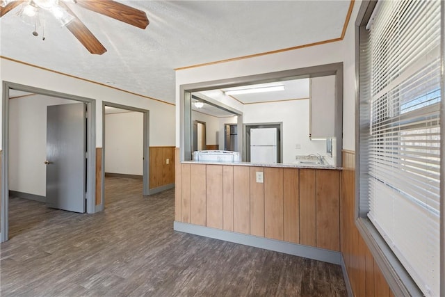 300 Range St, Marshall, AR 72650 - kitchen featuring freestanding refrigerator, a wainscoted wall, wood walls, and dark wood finished floors