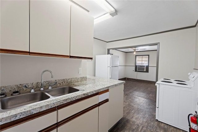 300 Range St, Marshall, AR 72650 - kitchen with light countertops, white appliances, dark wood finished floors, white cabinetry, and a sink