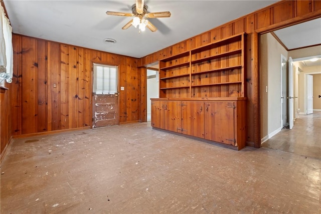 300 Range St, Marshall, AR 72650 - unfurnished living room featuring wood walls, ornamental molding, baseboards, visible vents, and a ceiling fan