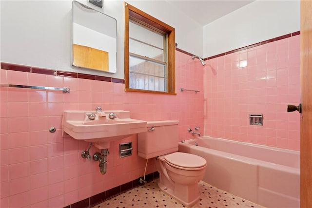300 Range St, Marshall, AR 72650 - full bathroom with tile walls, toilet, shower / bath combination, and wainscoting