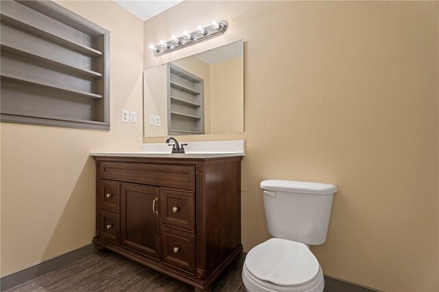 300 Range St, Marshall, AR 72650 - half bath featuring baseboards, toilet, vanity, and built in shelves