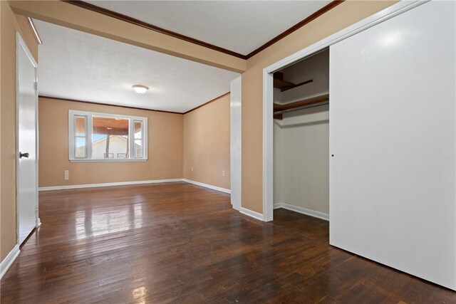 300 Range St, Marshall, AR 72650 - unfurnished bedroom featuring baseboards, a closet, crown molding, and wood finished floors