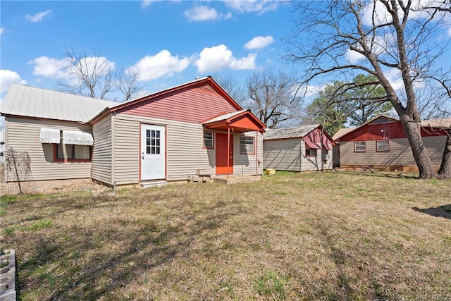 300 Range St, Marshall, AR 72650 - rear view of property with a lawn and metal roof