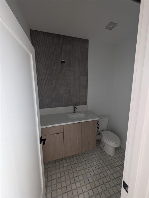 bathroom with toilet and vanity