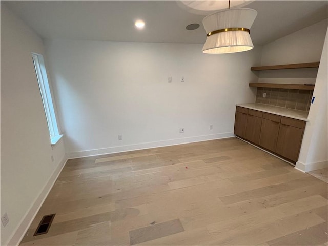 111 S Paddock Loop, Fayetteville, AR 72701 - unfurnished dining area featuring light wood-style floors and baseboards