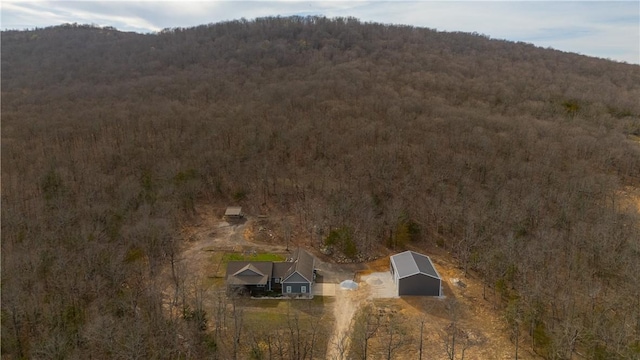 aerial view featuring a forest view and a mountain view