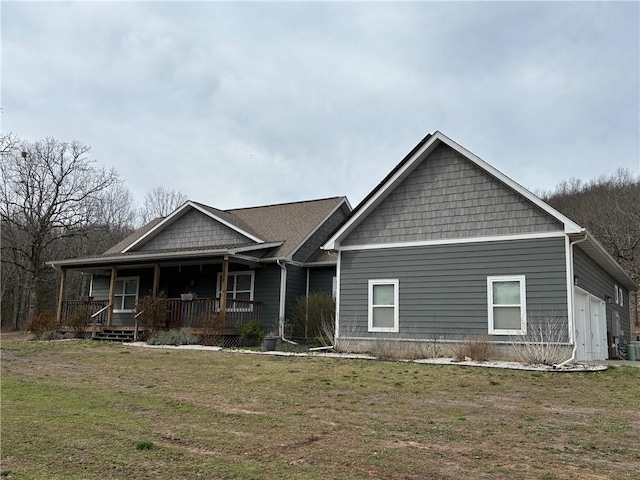 craftsman-style home with a porch, a front yard, and cooling unit