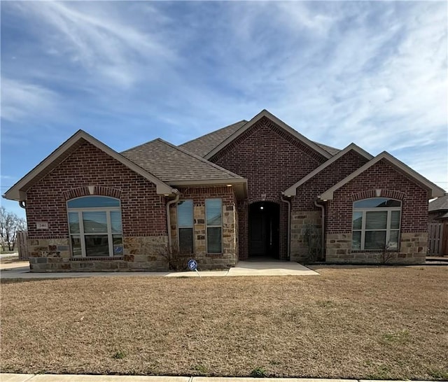 2401 Armstrong Ln, Pea Ridge, AR 72751 - view of front facade with stone siding, brick siding, roof with shingles, and a front lawn