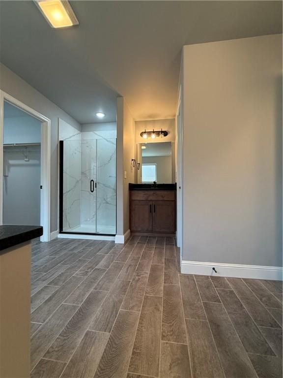 2401 Armstrong Ln, Pea Ridge, AR 72751 - full bathroom with a marble finish shower, vanity, baseboards, and wood tiled floor