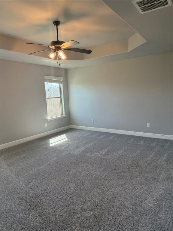 2401 Armstrong Ln, Pea Ridge, AR 72751 - unfurnished room with dark colored carpet, visible vents, baseboards, and ceiling fan