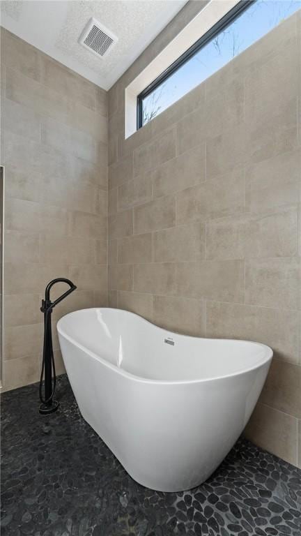 122 SW Gailey Hollow Rd, Siloam Springs, AR 72761 - bathroom with tile walls and a soaking tub