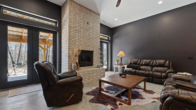 122 SW Gailey Hollow Rd, Siloam Springs, AR 72761 - living area with a fireplace, ceiling fan, finished concrete floors, french doors, and recessed lighting