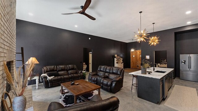 122 SW Gailey Hollow Rd, Siloam Springs, AR 72761 - living room with ceiling fan, a fireplace, a chandelier, recessed lighting, and concrete flooring