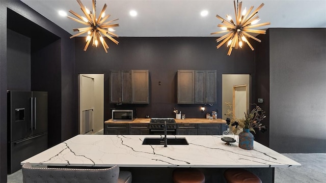 122 SW Gailey Hollow Rd, Siloam Springs, AR 72761 - kitchen featuring freestanding refrigerator, a chandelier, stainless steel microwave, a sink, and a high ceiling
