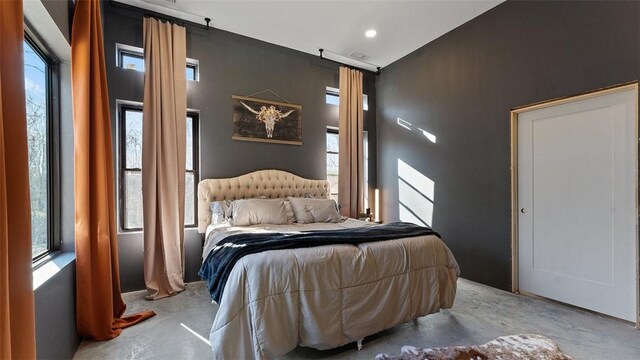 122 SW Gailey Hollow Rd, Siloam Springs, AR 72761 - bedroom featuring concrete floors, multiple windows, and recessed lighting