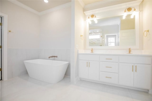 5914 SW Bloomsbury Rd, Bentonville, AR 72713 - bathroom with crown molding, double vanity, a freestanding tub, and wainscoting