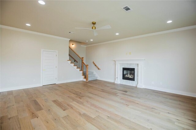 5914 SW Bloomsbury Rd, Bentonville, AR 72713 - unfurnished living room featuring stairs, ornamental molding, light wood finished floors, a ceiling fan, and recessed lighting