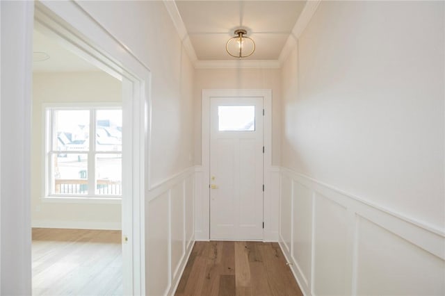 5914 SW Bloomsbury Rd, Bentonville, AR 72713 - doorway with a decorative wall, plenty of natural light, light wood finished floors, wainscoting, and ornamental molding