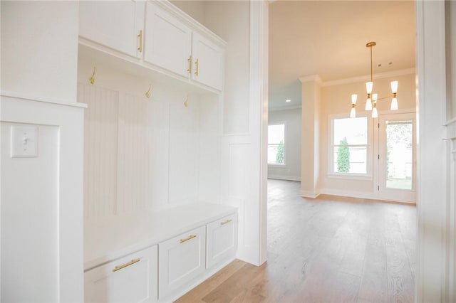 5914 SW Bloomsbury Rd, Bentonville, AR 72713 - mudroom with crown molding, light wood-style floors, a chandelier, and a decorative wall